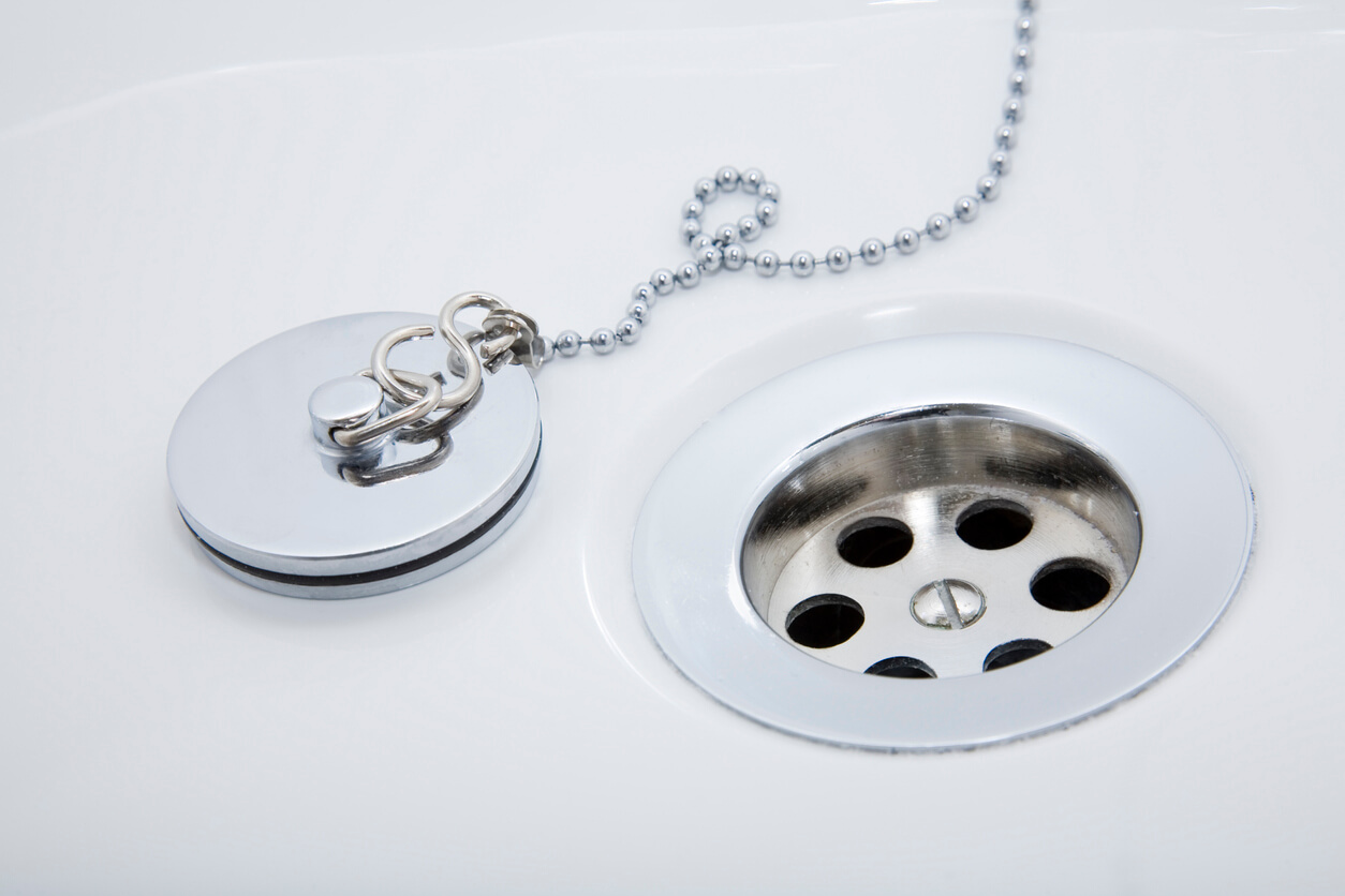 A bathtub drain and stopper.