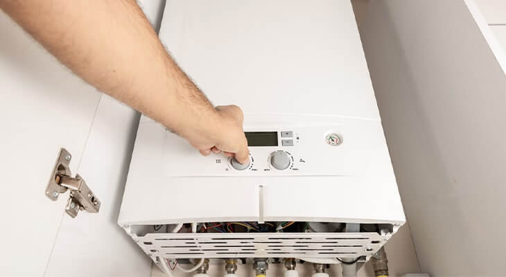man turning on combi gas boiler