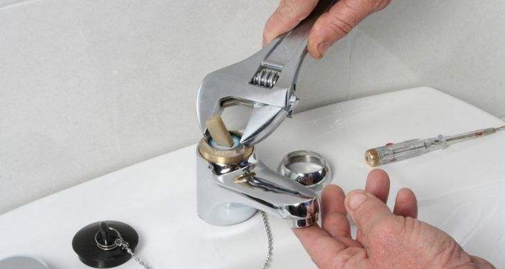 Plumber fixing a tap in Dorset